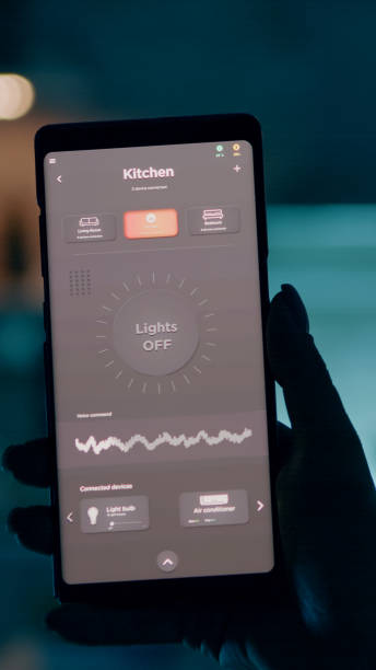 istock Woman holding smartphone with voice activation smart light app 1922568701