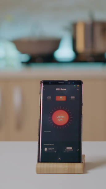 istock Smart home application on phone placed on kitchen desk in empty house 1922572905