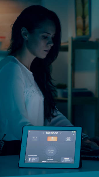 istock Remote woman working in modern house giving voice command to tablet 1922574000
