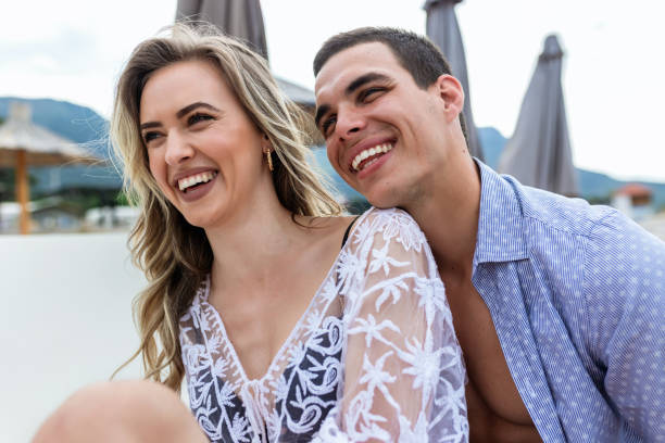 istock Happy young couple smilling and hugging on the beach. 1922575047