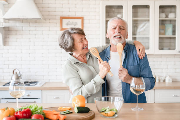 istock Overjoyed couple singing and dancing, hugging while cooking at home kitchen 1922578803