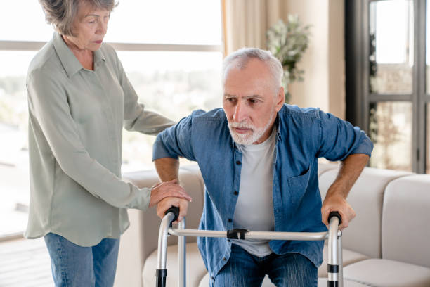 istock Old grandmother helping with walking and standing her disabled husband 1922580865
