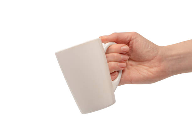 istock Female hand is holding tea cup isolated on a white background. 1922590591