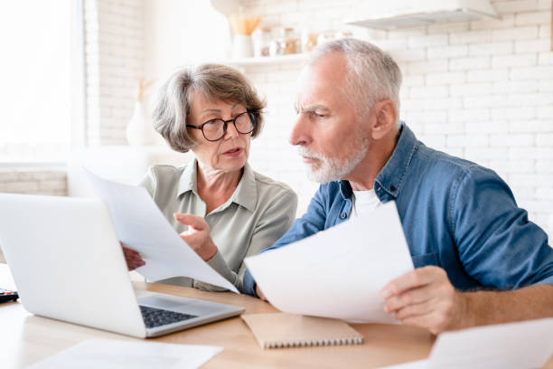 istock Concentrated couple doing paperwork, paying domestic bills 1922591126
