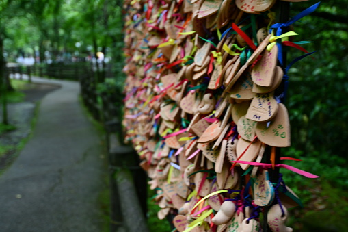 this wall is covered with many small wooden plaques of wish on it
