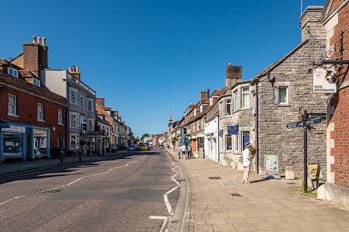 Top end of the High Street showing commercial premises and the traffic island / roundabout at Wilsons Corner. Largely deserted. Outdoors on a sunny spring day. April 26, 2020