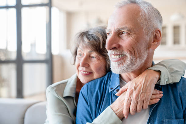 istock Happy spouses cuddling together while looking in future 1922616066