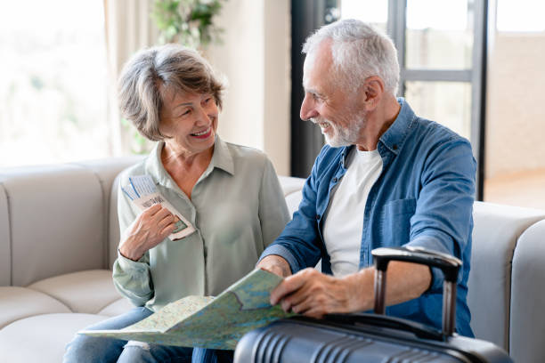 istock Senior husband and wife travelling together, using map to check the route 1922622441