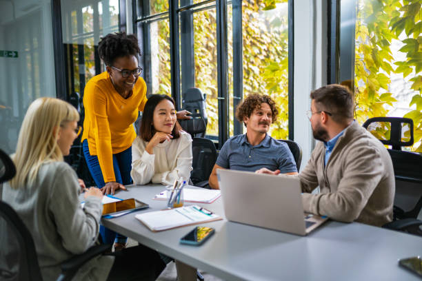 istock International workers group and team leader having teamwork discussion managing project at work in meeting room. 1922627121