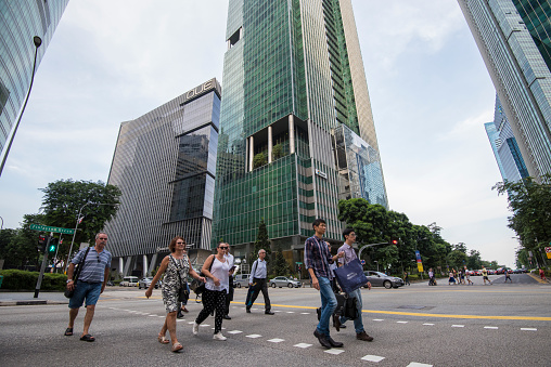 Singapore city, Singapore - September 08, 2019: At the end of the working day office workers walking on the streets of the Central Business District.