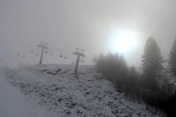 Closed chair lift in the mist, Piedmont, Northern Italy