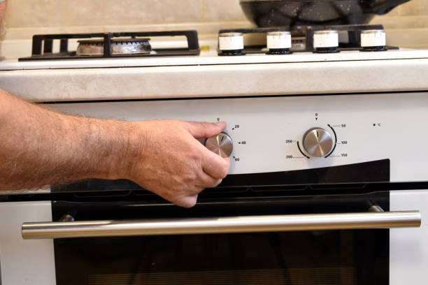 istock A hand turns the knob on the oven panel. 1922663960