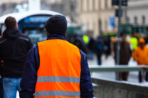 a person with a safety vest at a demo