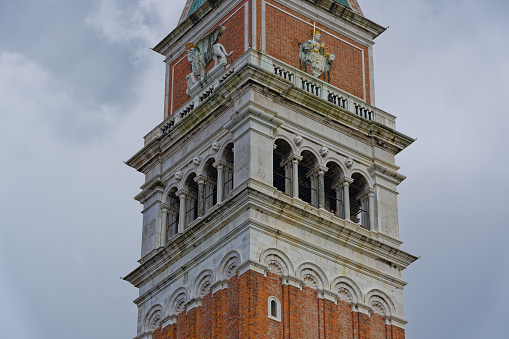 Looking up church tower of cathedral at Piazza san Marco at City of Venice on a sunny summer day. Photo taken August the 6th, 2023, Venice, Italy.