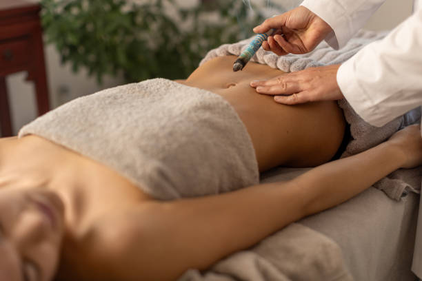 istock Woman lying down on a acupuncture bed, getting a treatment with moxa 1922692689