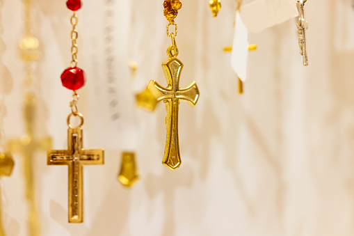 wooden rosary lying on a white sheet of paper