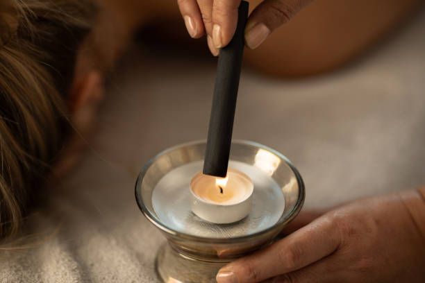 istock Woman lying down on a acupuncture bed, getting a treatment with moxa 1922694800