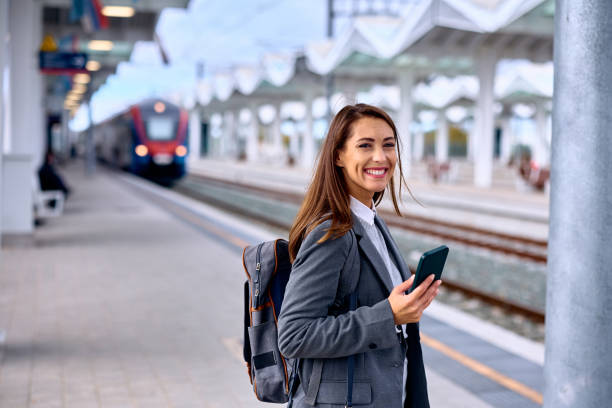 istock Young happy woman at train station looking at camera. 1922697441