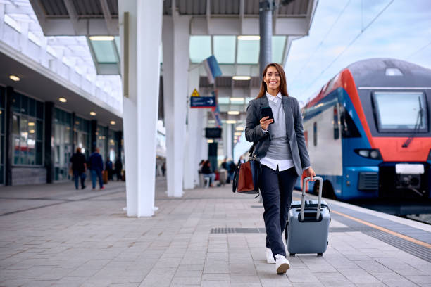 istock Young happy woman at train station. 1922697451