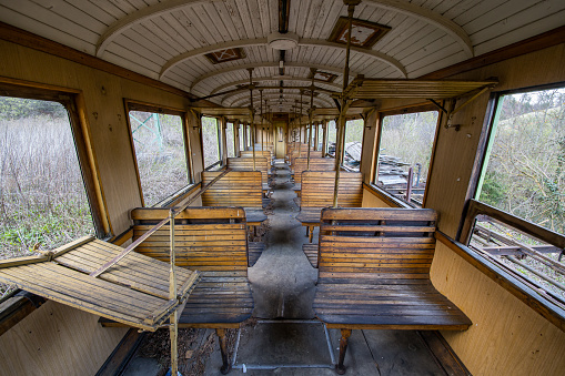 Abandoned train wagon with wooden interior on an old railroad track in Austria