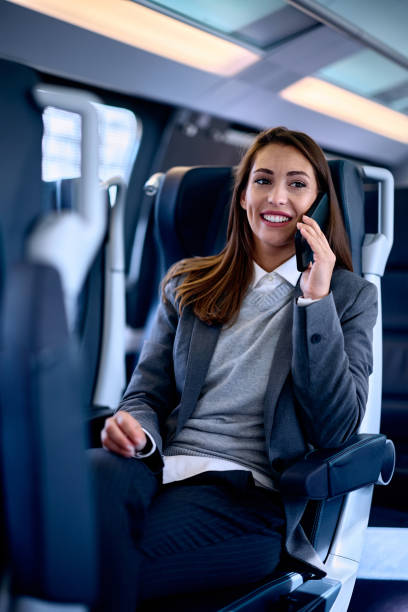 istock Happy businesswoman making a phone call while riding in a train. 1922700651