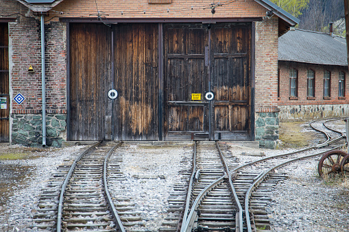Old train workshop with rails on the historic and abandoned railway in Payerbach, Reichenau in Austria