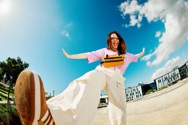 gen z teenager poses full body towards camera, showing attitude - fischauge stock-fotos und bilder