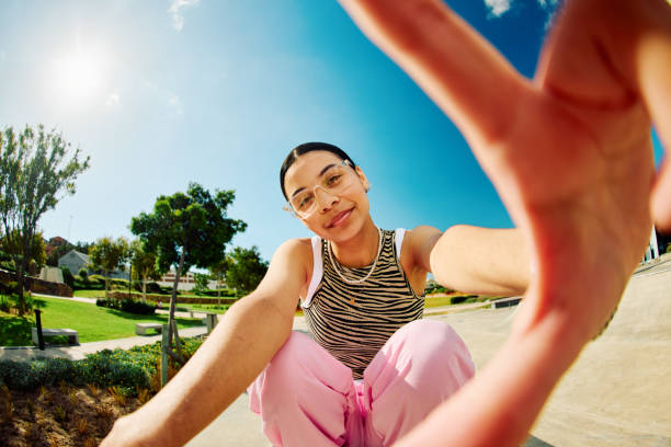 Carefree Generation Z Girl in Front of Blue Sky stock photo