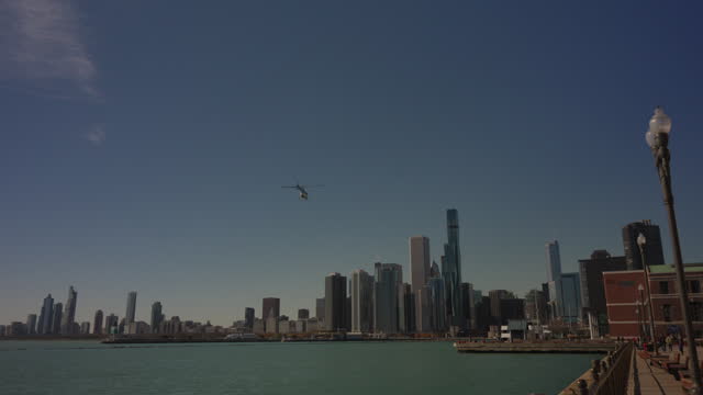 Helicopter above pier. Spectacular skyscrapers of Chicago city from Navy Pier