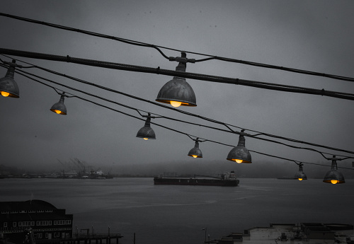 Industrial string lights over gloomy Puget sound