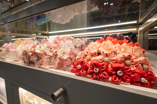 Headbands with fabric flowers for girls in the display stand