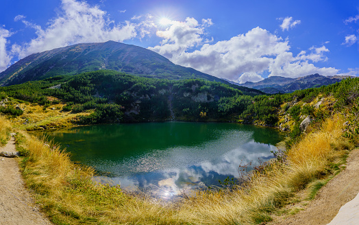 View of mountain landscape and Okoto Lake, in Pirin National Park, in southwestern Bulgaria