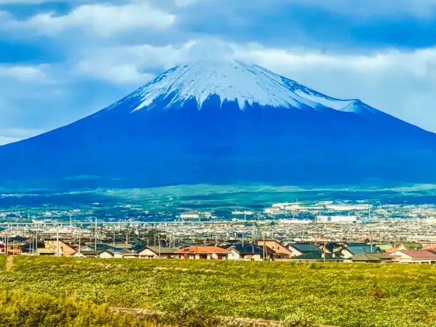 Colorful Snowy Mount Fuji Mountain From Bullet Train Buildings Kanagawa Japan. Highest mountain in Japan over 12,000 feet. Mount Fuji is a symbol of Japan.