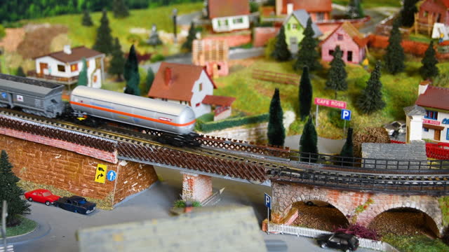 Model freight train moving on a mountain alpine ambientation. Model railway.