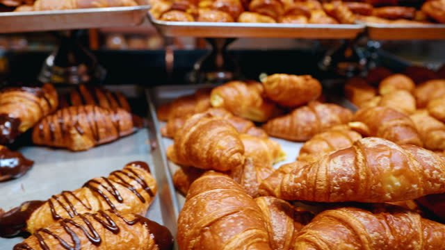 Food, bakery and grocery with croissant in supermarket shelf for shopping, pastry and retail. Cafe, dessert or display with baked product on showcase for restaurant, breakfast or confectionery choice