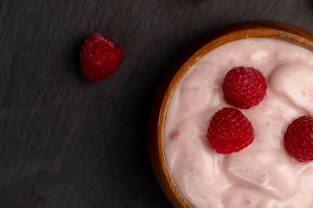 istock fresh yogurt with raspberry flavor, close up 1922783385