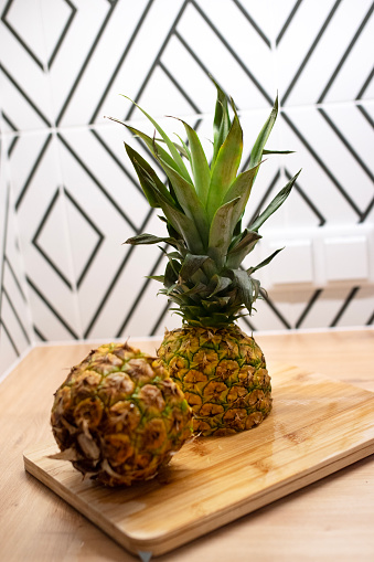 Fresh cut pineapple on a cutting board in the kitchen.