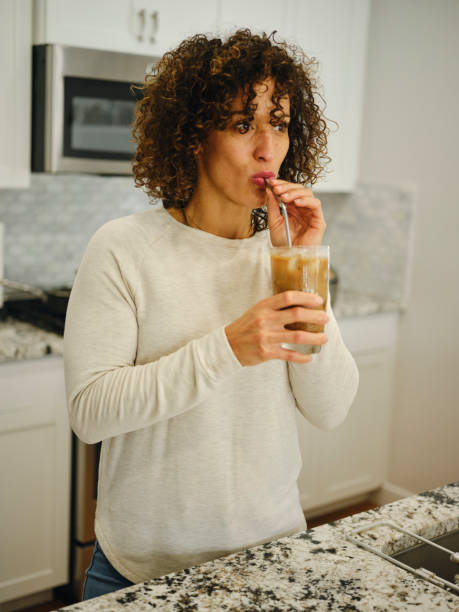 istock Woman in a Home Kitchen Drinking 1922822599