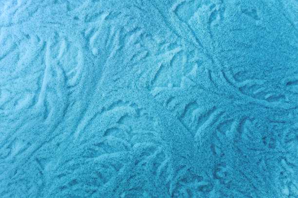 Frost on glass in frosty weather. Background and texture. Nature drawings.