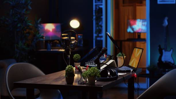 istock Empty studio with high tech microphone, audio mixer and headphones used to record podcast 1922907206