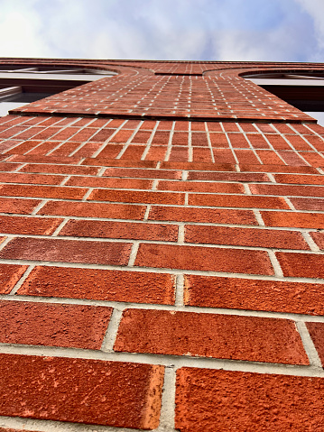 Brick wall from below and blue sky looking up