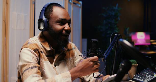 istock Zoom in on man on podcast discussing with guest during marathon stream 1922920263