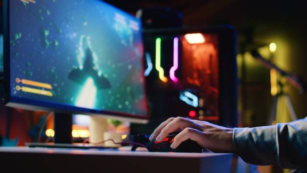 istock Man using gaming mouse to play entertaining videogame, flying spaceship through galaxy, close up 1922925959