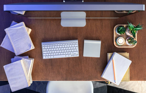 istock Student desk with computer, books and notepads on a wooden table. 1922952267