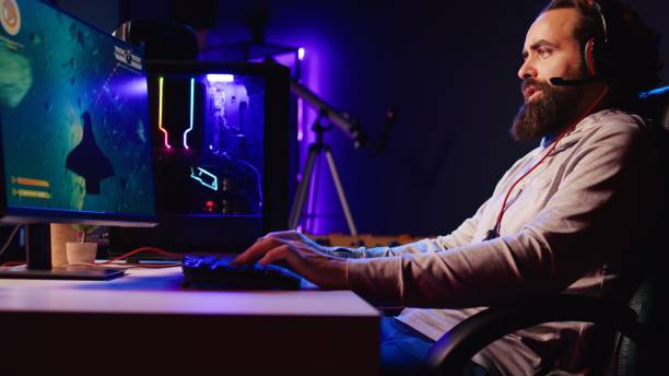 istock Man in neon lit apartment playing singleplayer videogame with spaceship shooting laser bullets 1922970556