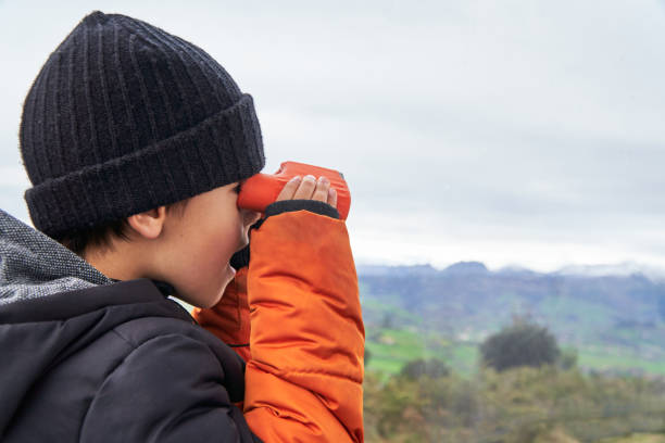 istock Surprised kid looking the meadow with binoculars during winter holidays 1922975195