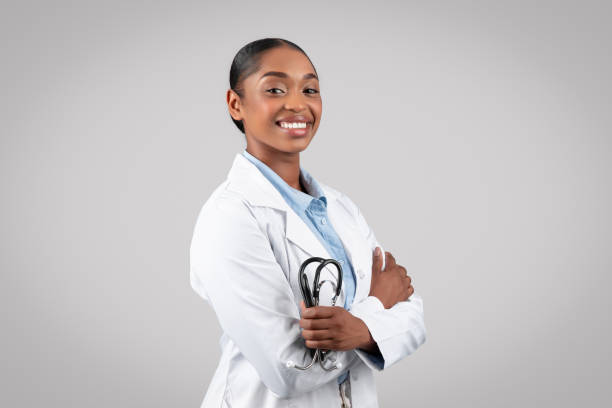 istock Confident smiling black millennial doctor in white coat, with stethoscope 1922985259