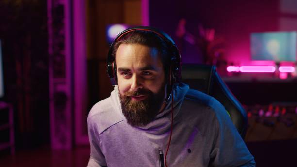 istock Man recording himself competing in videogame tournaments online while streaming 1922985271