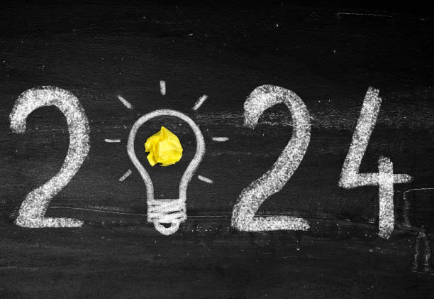 istock Bulb light with new year 2024 on chalkboard 1923012327