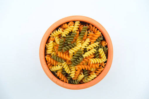 Heap of raw tricolor Fusilli gluten free pasta stock photo